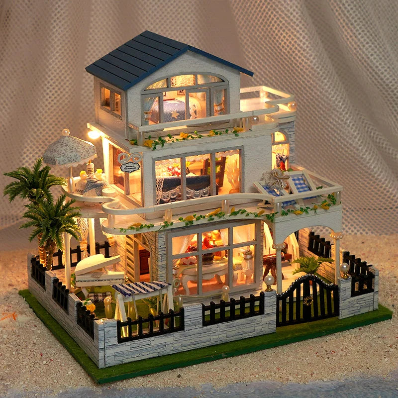 A detailed wooden mini seaside villa dollhouse kit featuring a two-story structure with furniture and landscaping.