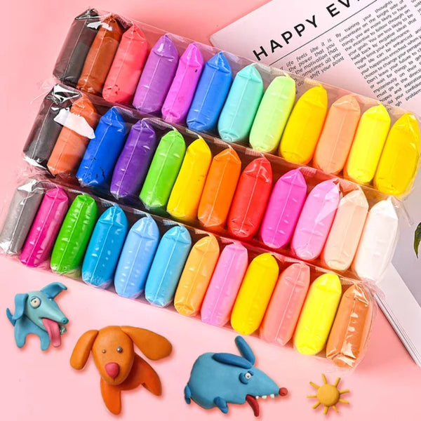 A colorful air dry modeling clay kit featuring various sculpted shapes and tools on a pink background.