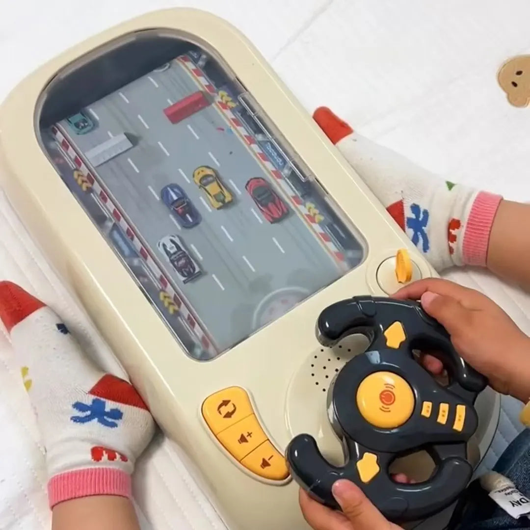 A child is holding a yellow and black interactive steering wheel driving toy with sound effects on a white surface.