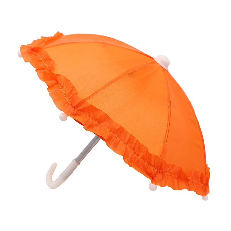 An orange umbrella with a lace trim and bear design is shown open.