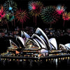 A night scene featuring the Sydney Opera House illuminated by fireworks over a body of water.