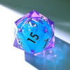 A handmade resin D20 die with a large blue and purple liquid swirl, viewed at an angle.