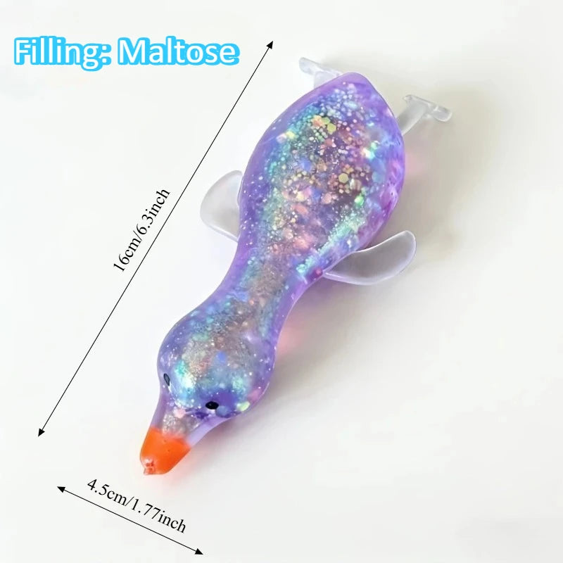 A purple squishy duck fidget toy with a multicolored filling and an orange beak.