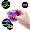A hand squeezes a purple glitter ice cube sensory fidget toy, demonstrating its soft and firm texture.