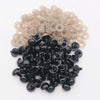 A pile of black plastic safety eyes with washers for crafting and stuffed animals