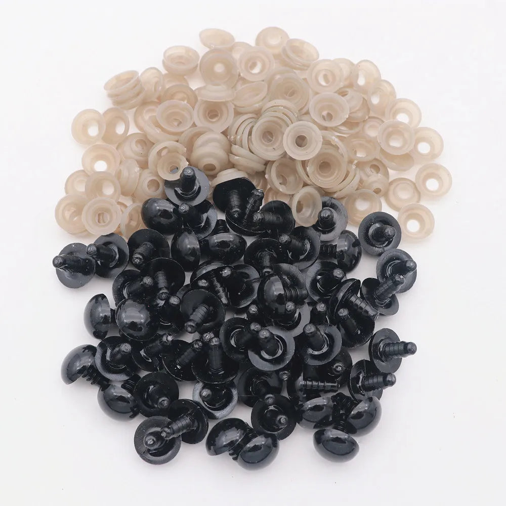 A pile of black plastic safety eyes with washers for crafting and stuffed animals