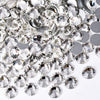 A pile of clear and silver sparkling crystal flatback rhinestones for nail art and crafts.