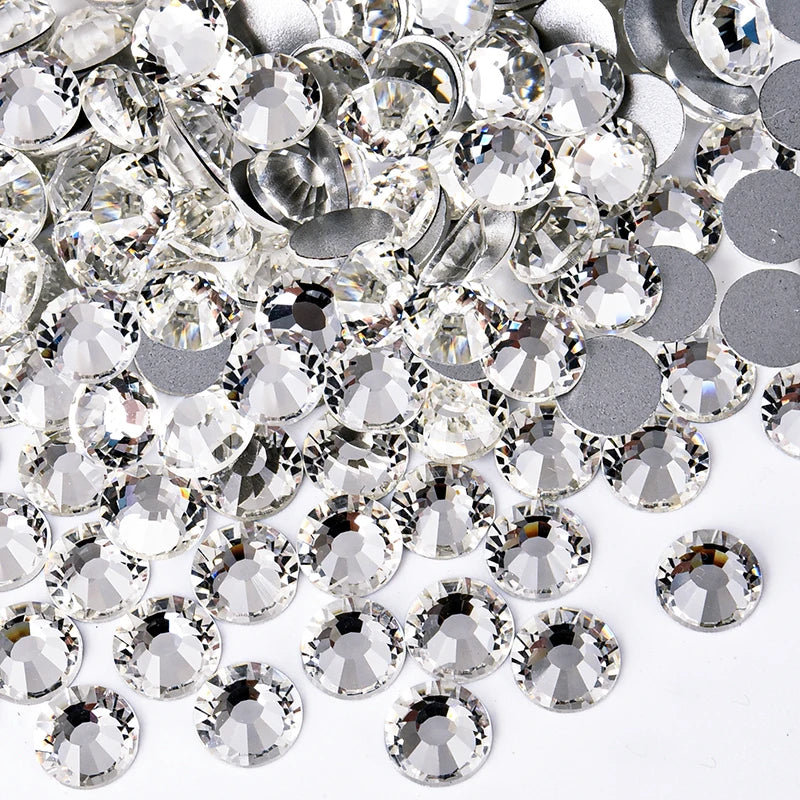 A pile of clear and silver sparkling crystal flatback rhinestones for nail art and crafts.