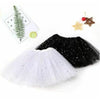 A black tulle tutu skirt and a white sparkly tutu skirt are displayed with decorative stars.