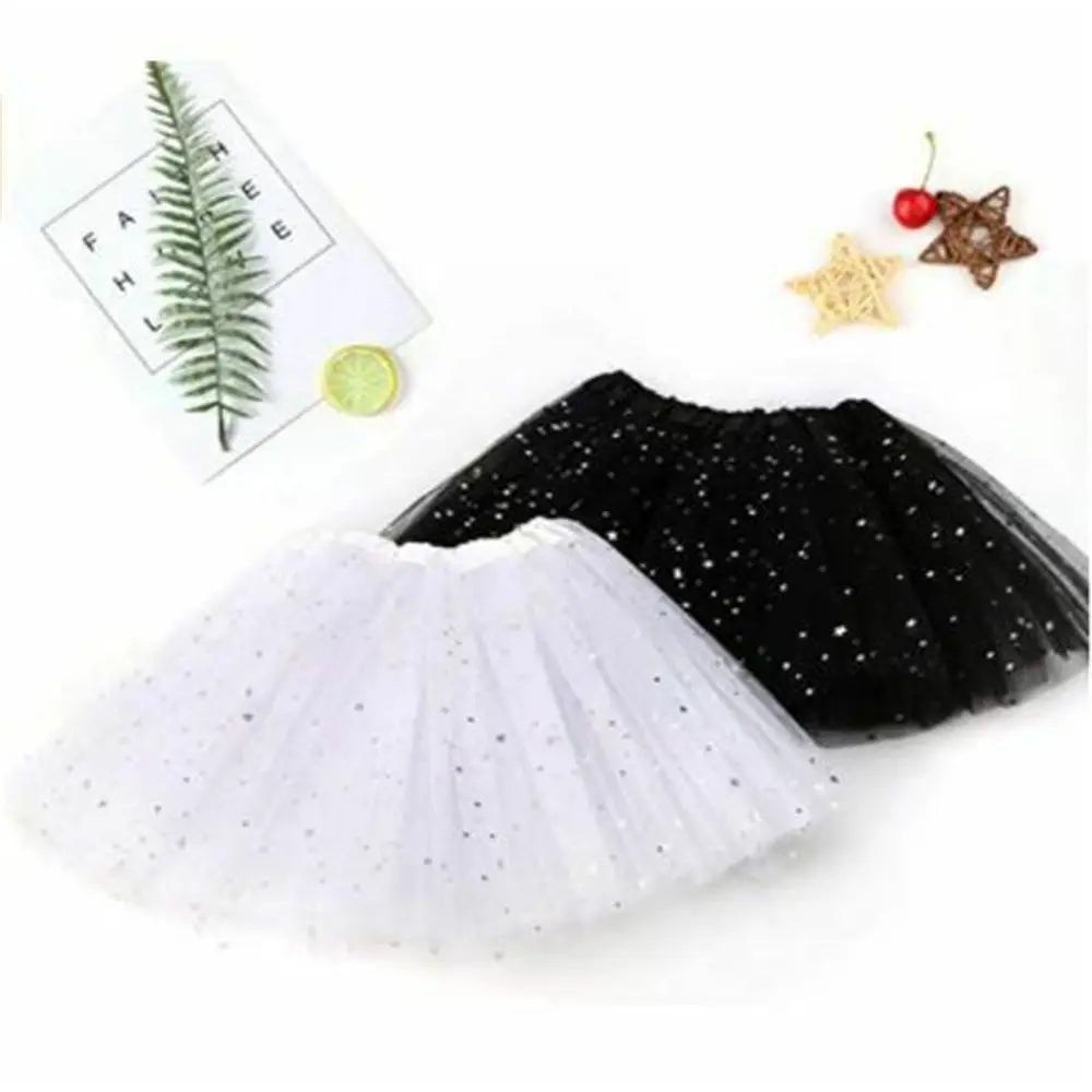 A black tulle tutu skirt and a white sparkly tutu skirt are displayed with decorative stars.