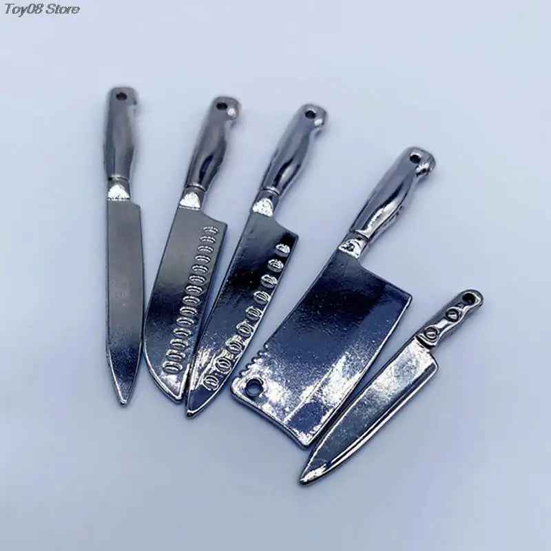 A set of miniature metal kitchen knives with handles displayed on a light gray background.
