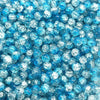 A close-up view of small, round, blue glass crackle beads for jewelry making.