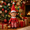 A festive Christmas elf decoration in a red suit and hat stands in front of a decorated Christmas tree.