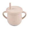 A light pink BPA-free silicone snack cup with a lid is shown.