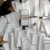 A collection of vintage scrapbooking paper sheets in white and beige tones for journaling and crafts.