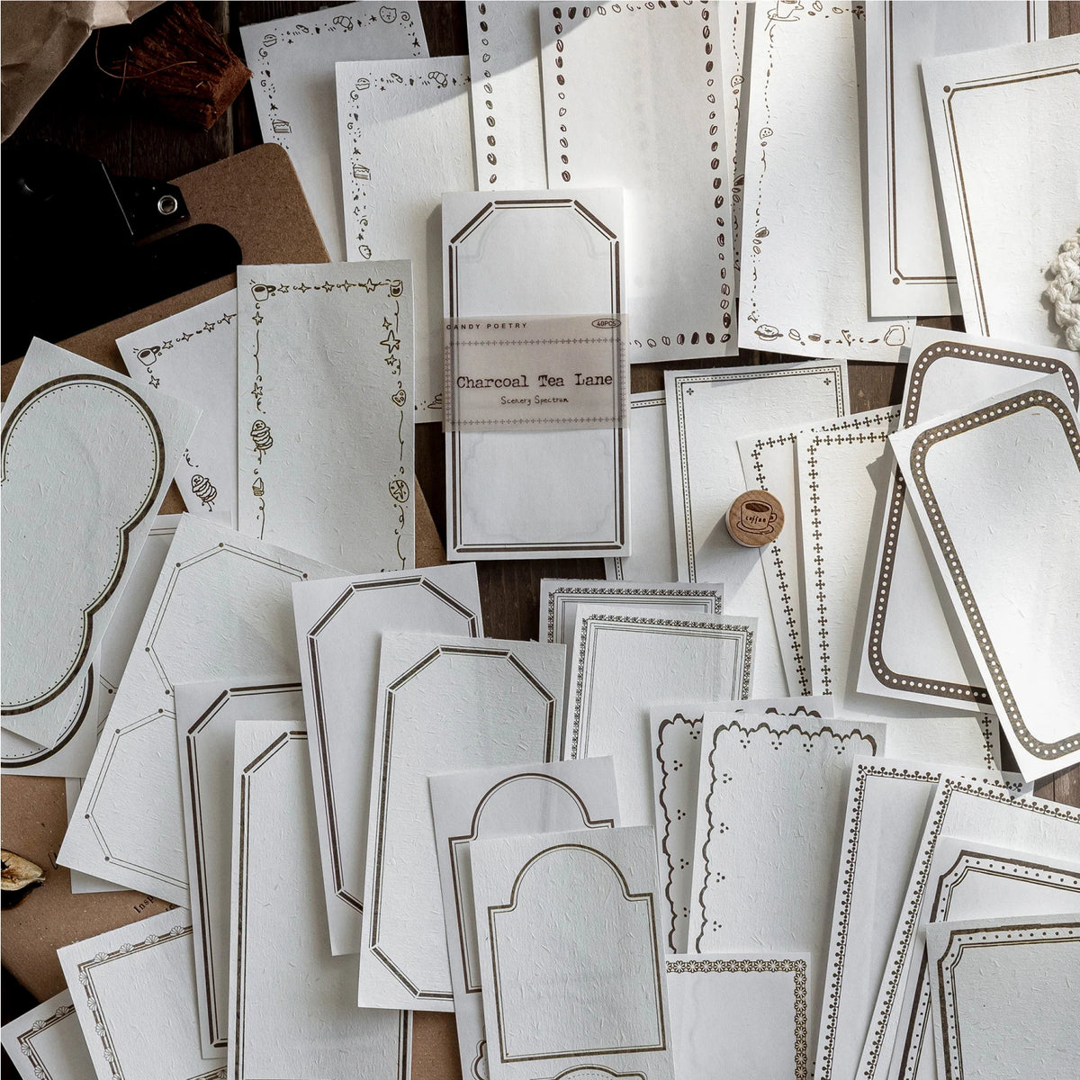 A collection of vintage scrapbooking paper sheets in white and beige tones for journaling and crafts.