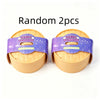 Two random squishy dumpling stress relief toys in purple and yellow packaging
