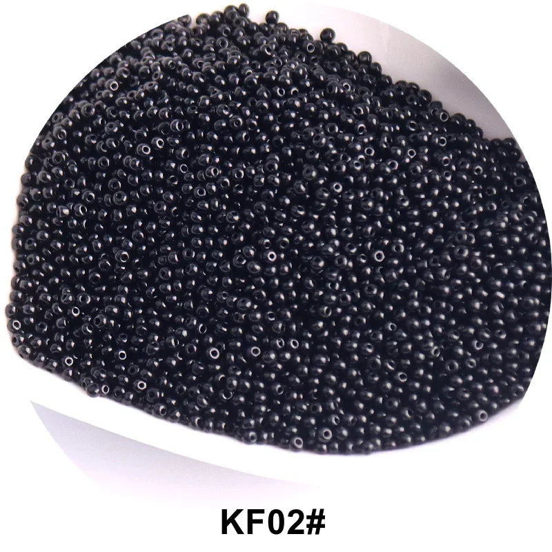 A pile of black seed beads, identified as KF02#, used for jewelry and craft.