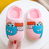 Pink plush slippers shaped like cartoon dinosaurs with blue accents