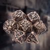A set of coppery skull metal polyhedral dice for tabletop role-playing games