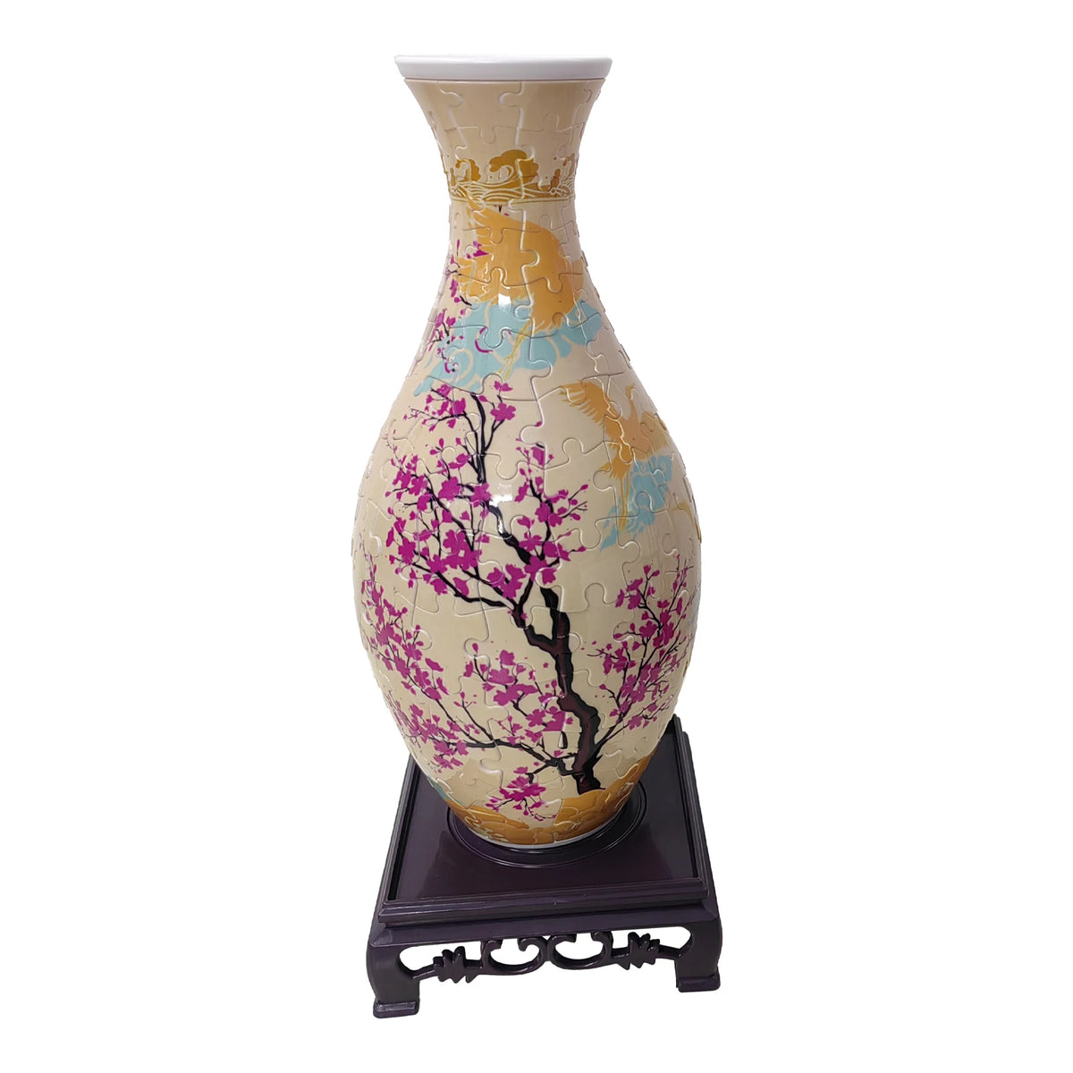 A ceramic flower vase painted in yellow and pink with blue accents, featuring a 3D puzzle design.
