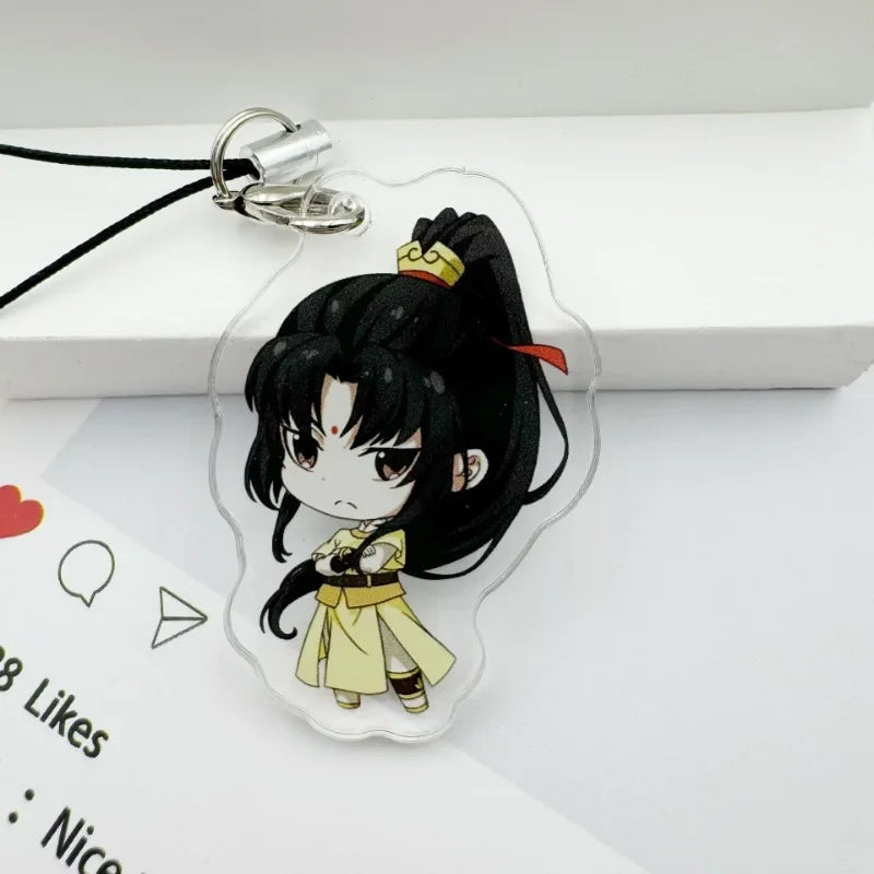 A clear acrylic pendant featuring an anime-style character with black hair and yellow clothing attached to a black cord.