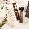 A collection of film strips, paper, and stickers for DIY crafts laid out on a white surface.