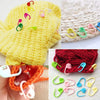 A collection of colorful locking stitch markers for knitting and crochet, including yellow, pink, green, and blue plastic rin