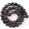A collection of dark, speckled natural sea sediment jasper and turquoise beads for jewelry making.