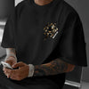 A man wearing a black graphic cotton t-shirt featuring a tiger claw design and the text Never Give Up.