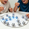 Two children are playing with a magnetic soccer strategy board game on a white table.