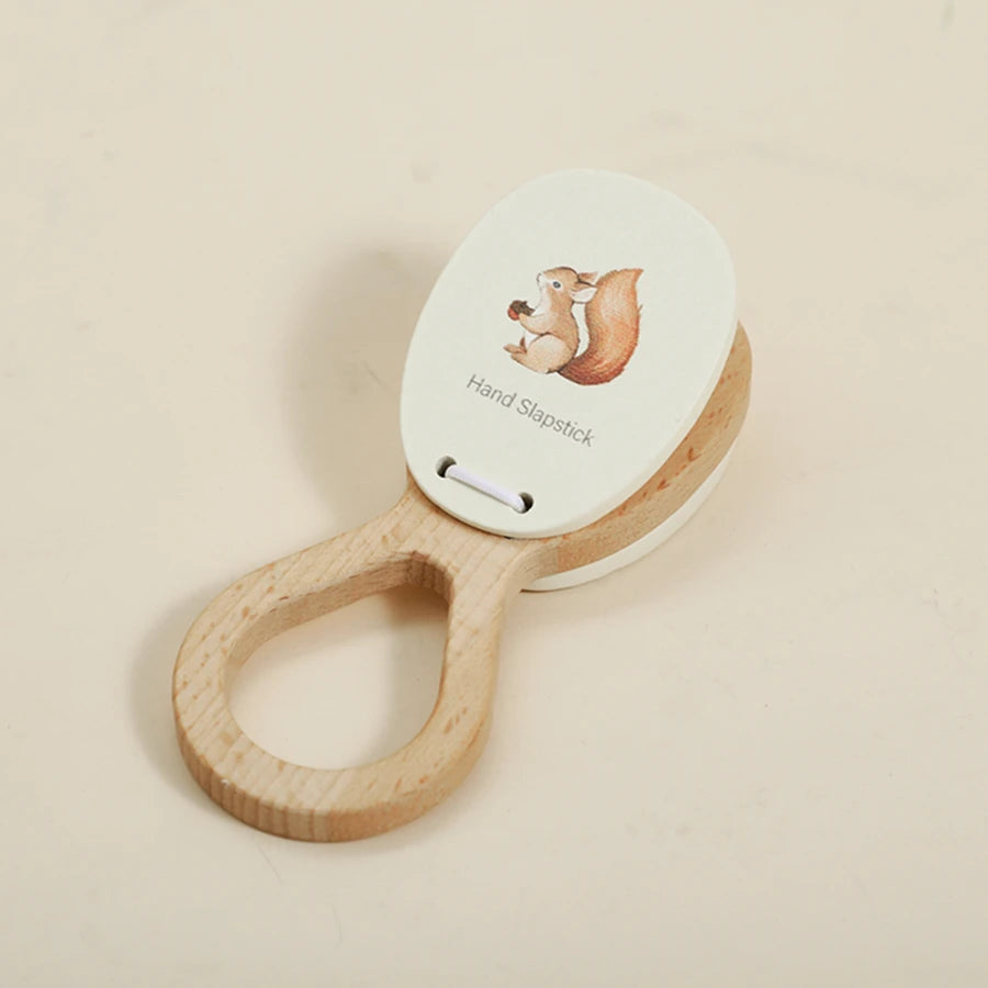 A wooden hand slapstick toy featuring a bear illustration for toddlers.