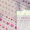 A sheet of rhinestone nail art stickers featuring various pink and purple heart shapes and glitter accents.