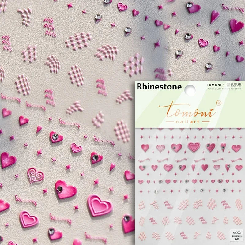 A sheet of rhinestone nail art stickers featuring various pink and purple heart shapes and glitter accents.