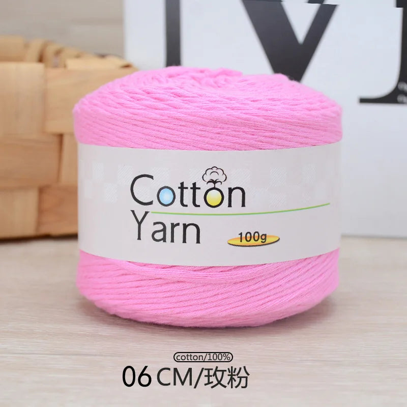 Pink 100% cotton yarn in a spool with a label indicating 100g and 06 cm length.