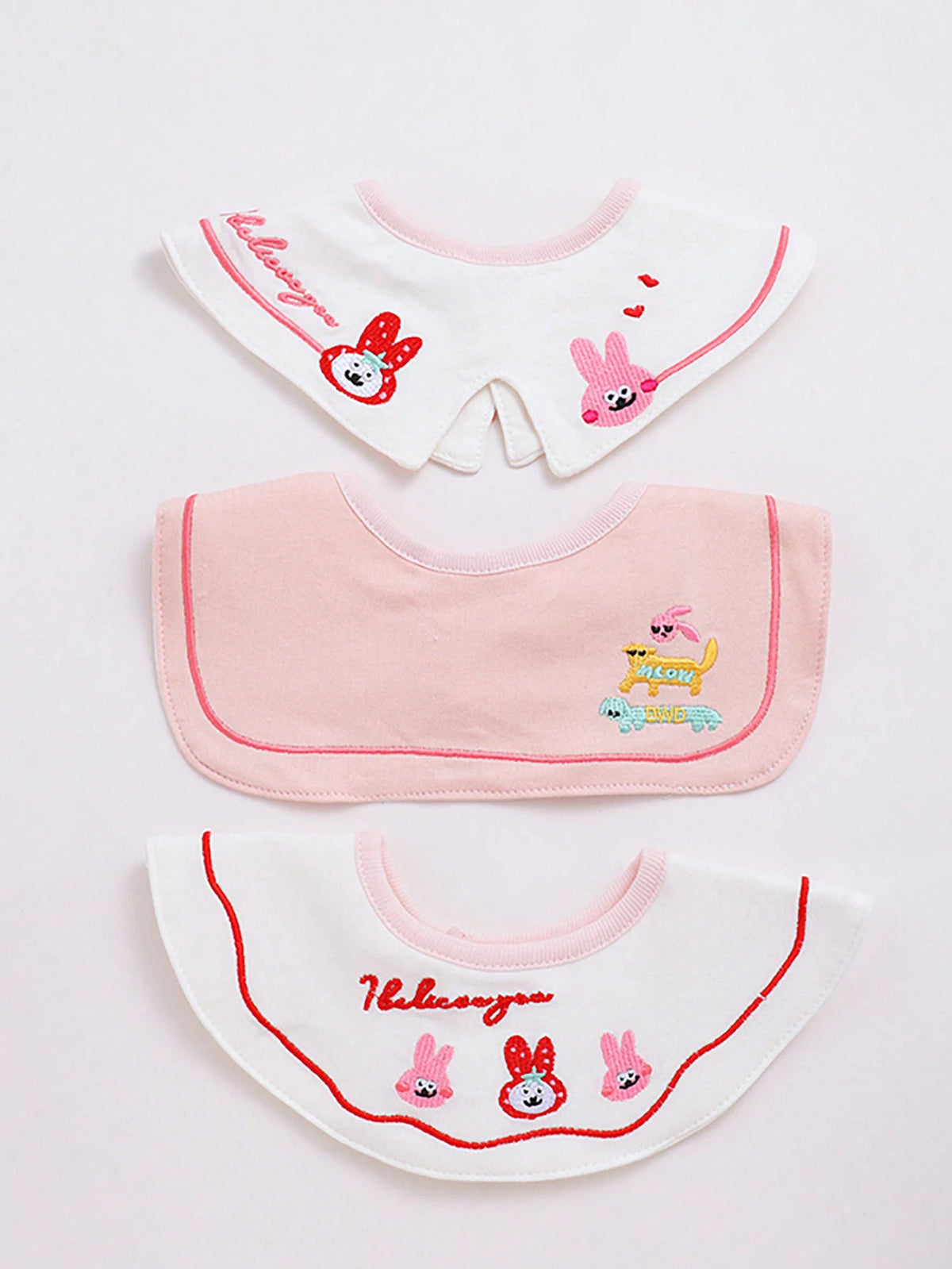 A set of three pink and white baby waterproof drool bibs featuring cute animal designs