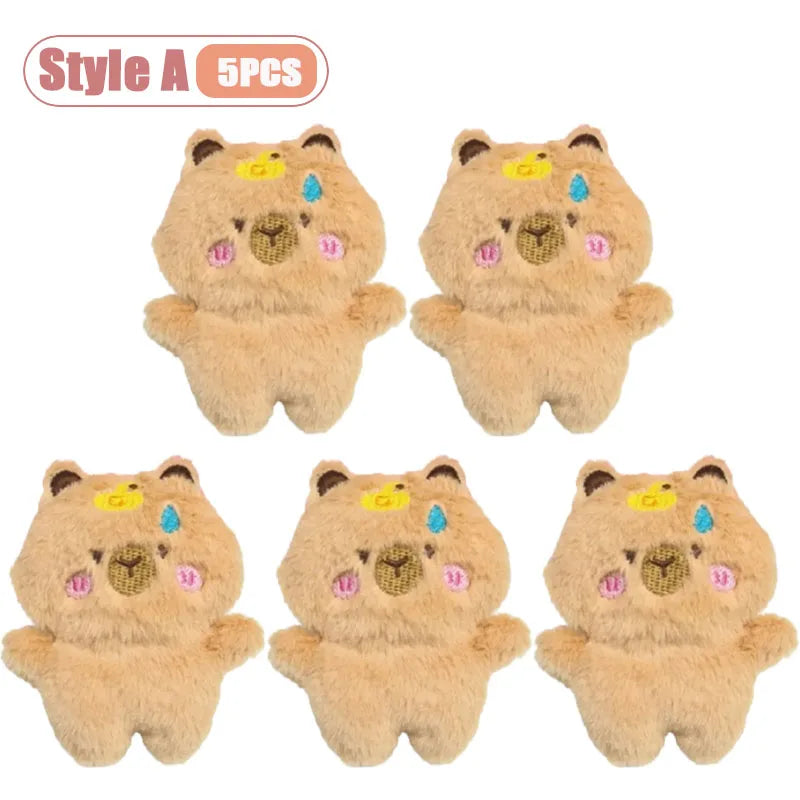 Five cute tan capybara plush keychains or bag charms