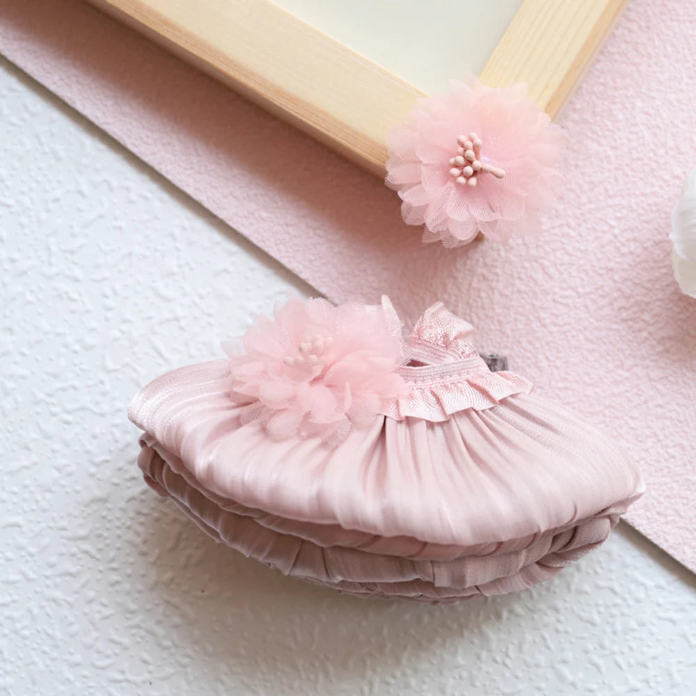 A pink satin mini doll wedding dress outfit set with ruffled details and a floral embellishment