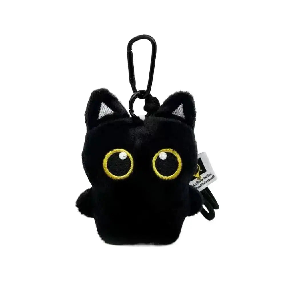 A cute plush black cat keychain with a gold-colored eye and a black loop.