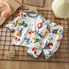 Kids' cotton pajama set featuring a repeating pattern of various toy vehicles for boys and girls