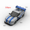 A white and blue classic supercar building block model with a transparent windshield and blue roof, shown from the side.