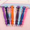 A row of precision diamond painting pens in various colors including purple, blue, orange, and pink.