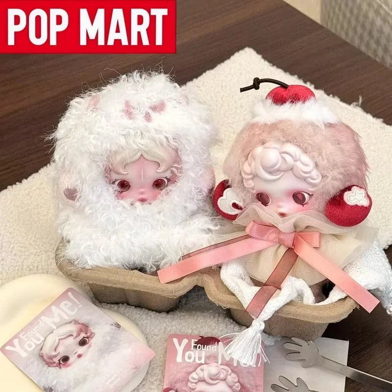 A collection of Skullpanda You Found Me! series collectible figures in a cardboard box with pink ribbon and white fluff.