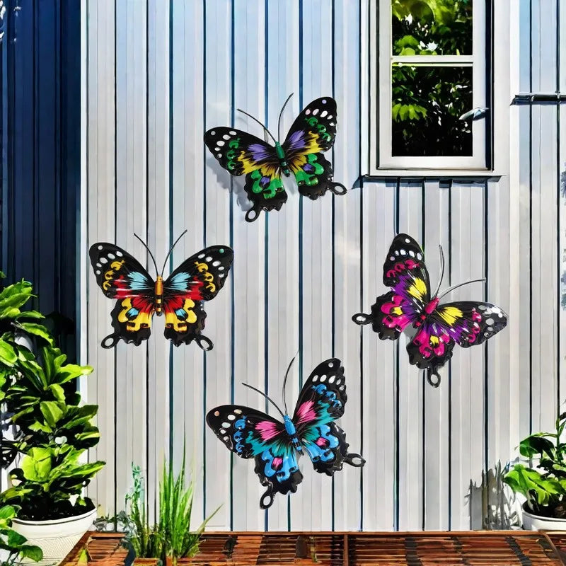 Set of four decorative iron butterflies displayed on a white vertical slat wall.