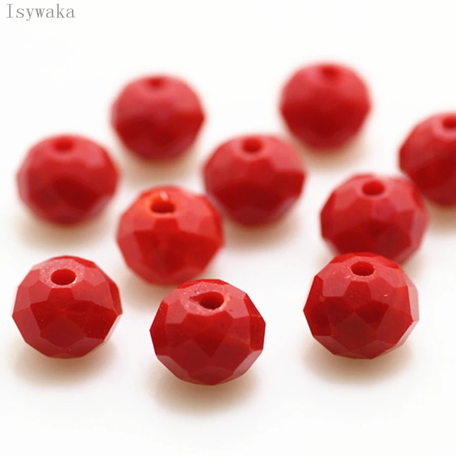 A collection of bright red, round crystal glass beads used for jewelry making.