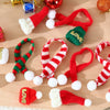 A set of mini knit Christmas hats and scarves in red, green, and white yarn for DIY crafts