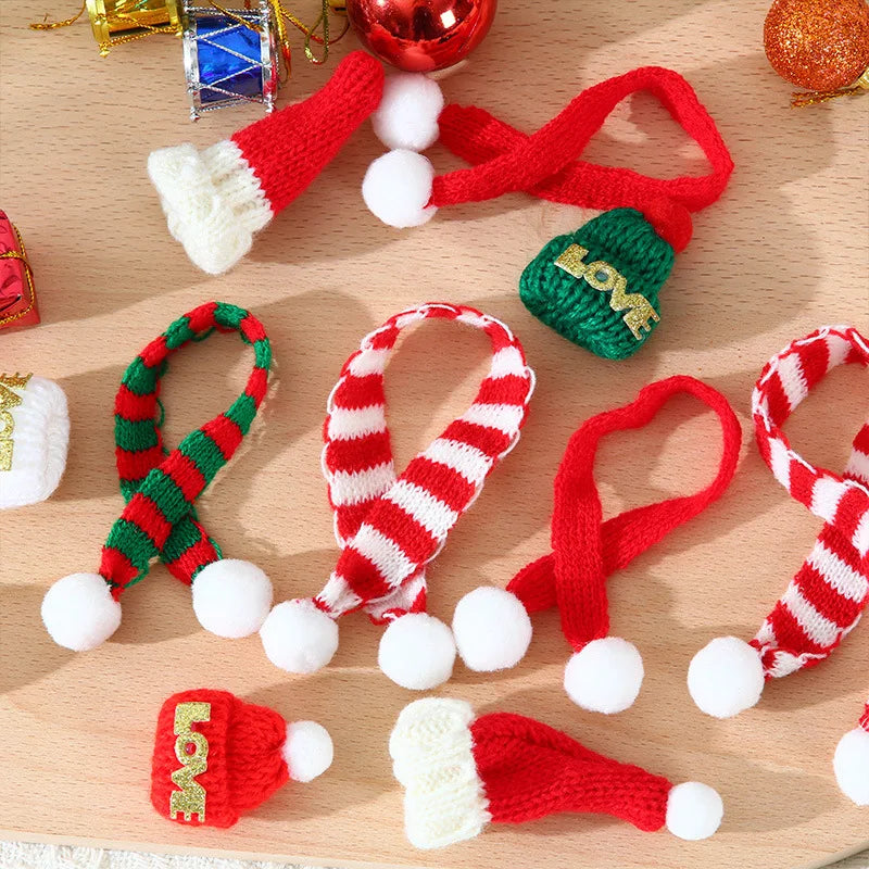 A set of mini knit Christmas hats and scarves in red, green, and white yarn for DIY crafts