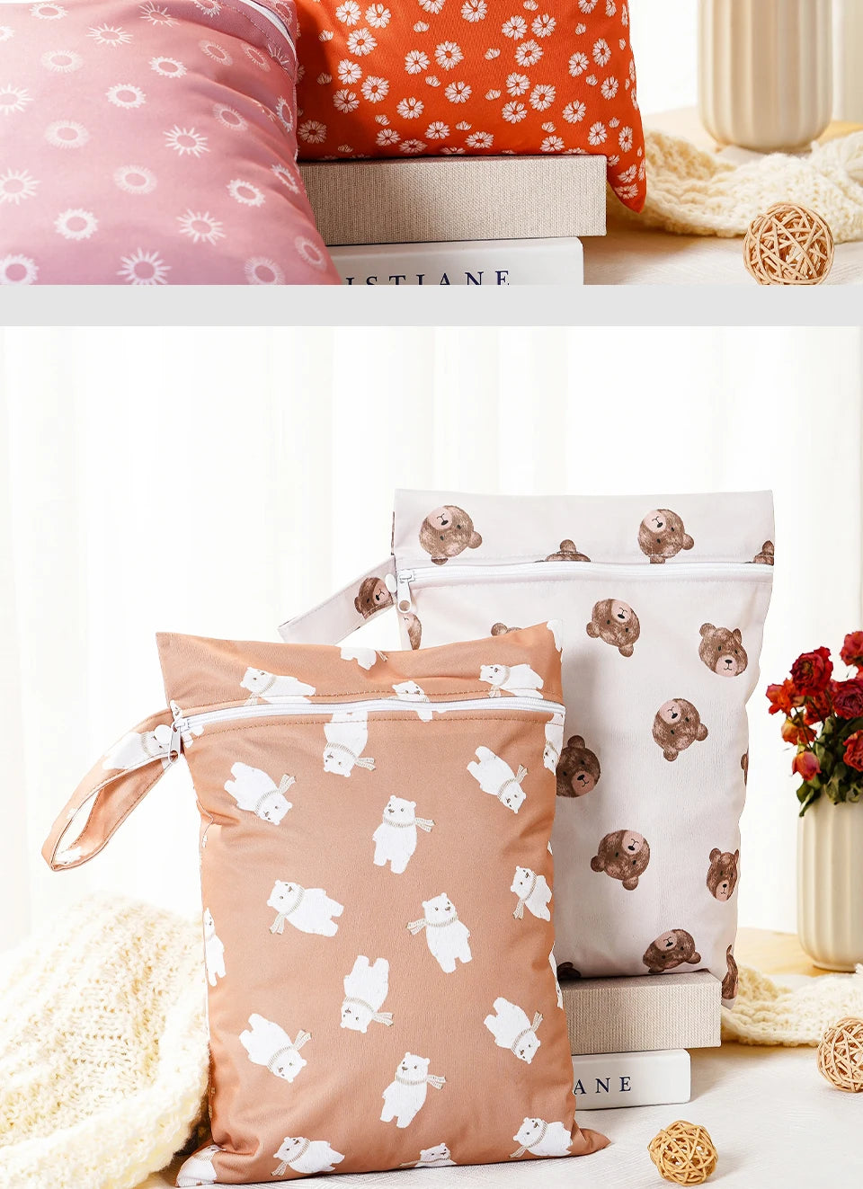 Two beige and pink reusable waterproof baby wet bags with bear patterns are displayed on a white surface.