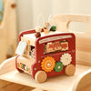 A red wooden animal tourism bus Montessori busy board for toddlers with wooden animals and features.