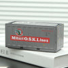 A silver industrial iron storage box labeled Mitsui O.S.K.Lines resting on a white book.